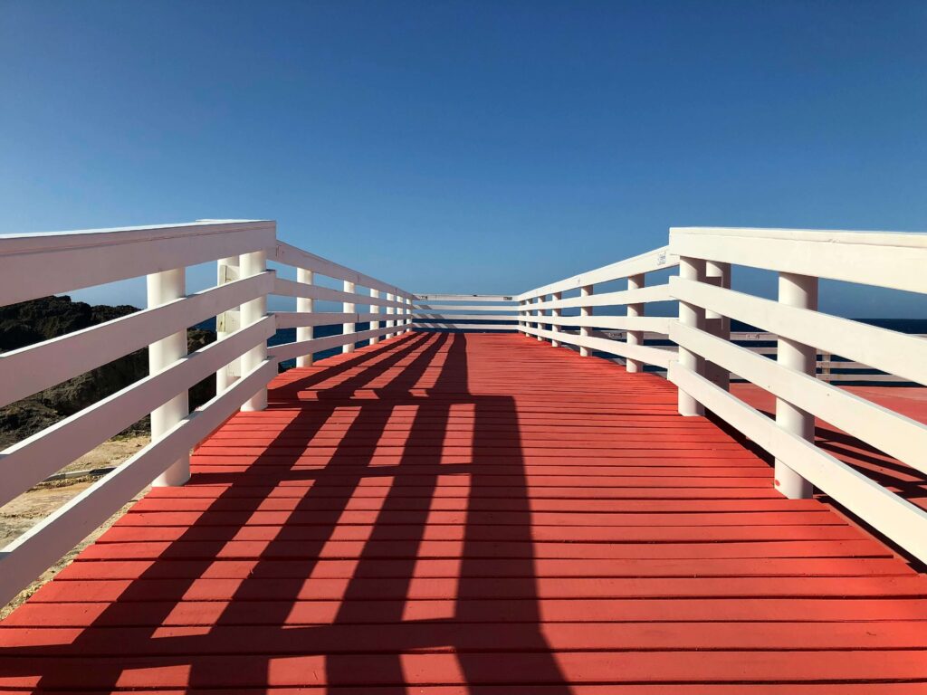 Outdoor timber bridge in bright sun illustrating UV exposure and coating durability on wood.